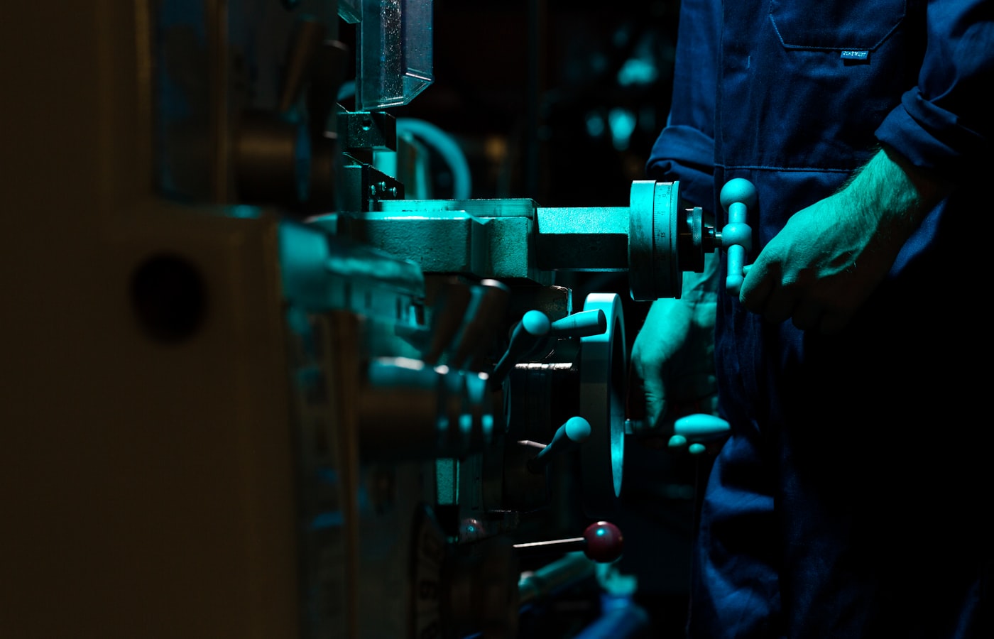 Skilled engineer operating industrial machinery in a control room