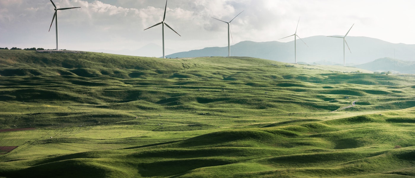 Wind farm landscape with multiple turbines on rolling green hills