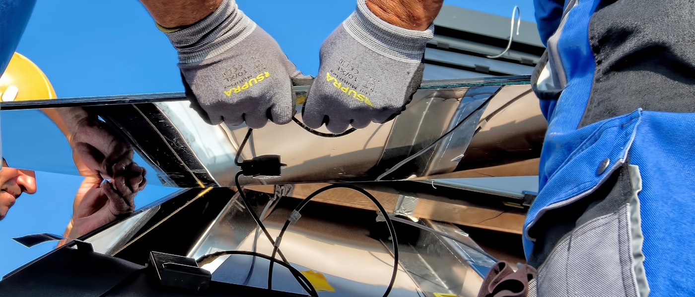 Electrical technicians installing equipment with safety gloves